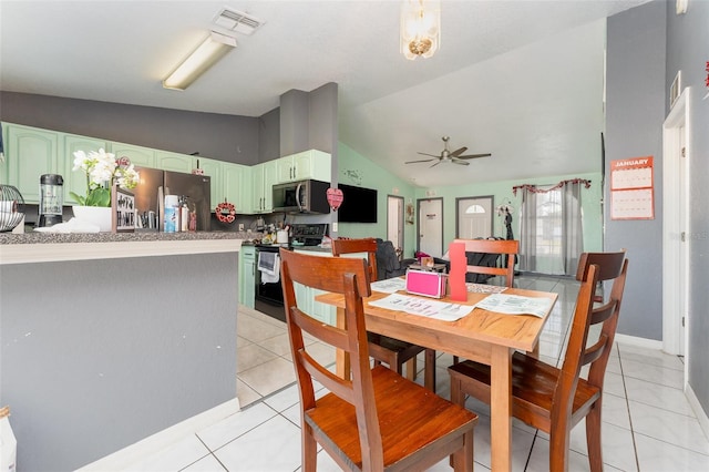 tiled dining area featuring lofted ceiling and ceiling fan