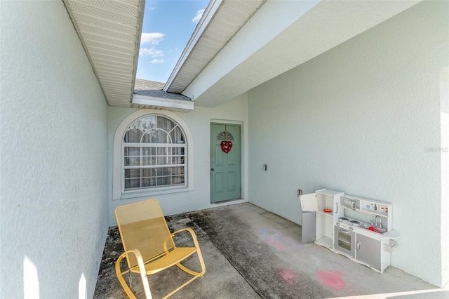 property entrance featuring a patio area