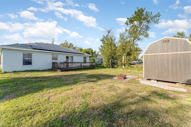 view of yard with a storage shed and a deck