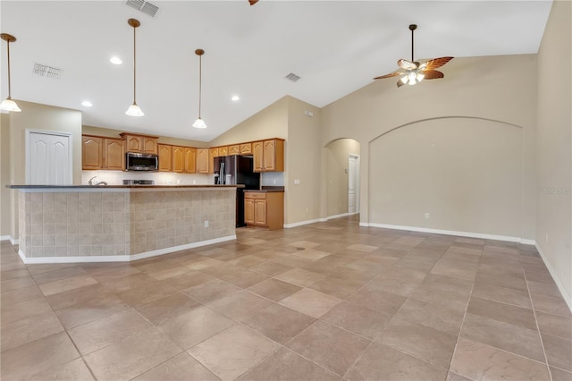 kitchen featuring hanging light fixtures, black fridge with ice dispenser, high vaulted ceiling, and ceiling fan