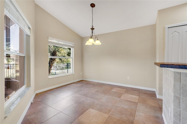 unfurnished dining area featuring vaulted ceiling and an inviting chandelier