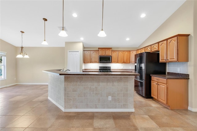 kitchen with vaulted ceiling, a kitchen island with sink, pendant lighting, and black appliances