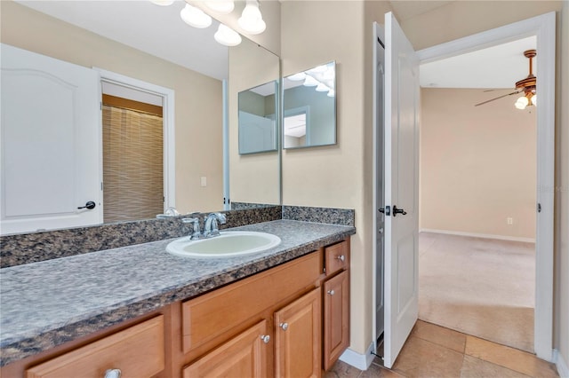 bathroom with ceiling fan, tile patterned floors, and vanity