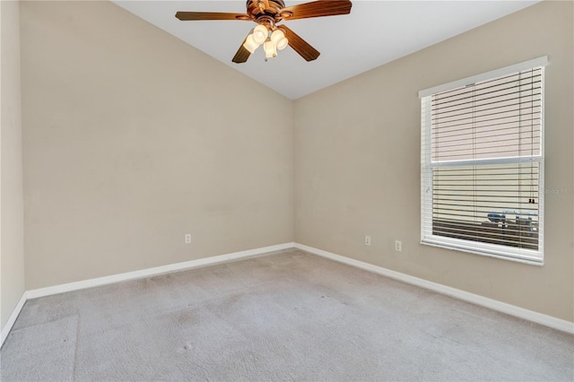 carpeted spare room with lofted ceiling and ceiling fan