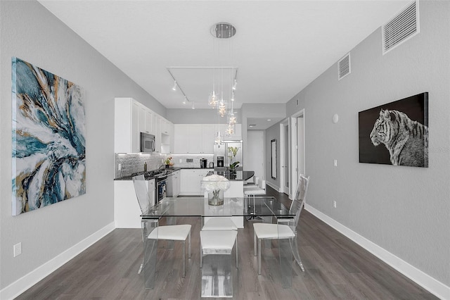 dining area featuring an inviting chandelier and dark hardwood / wood-style flooring