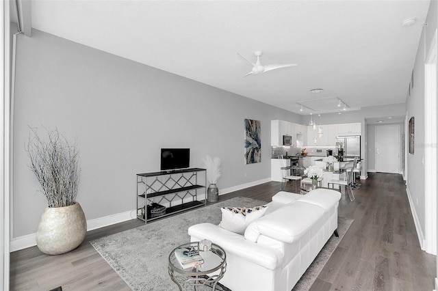 living room with wood-type flooring and ceiling fan