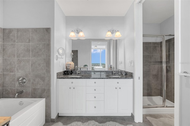 bathroom featuring vanity, independent shower and bath, and tile patterned flooring