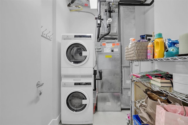 laundry room with stacked washing maching and dryer