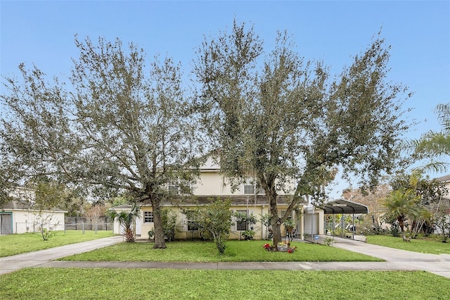 view of front of house with a carport and a front lawn