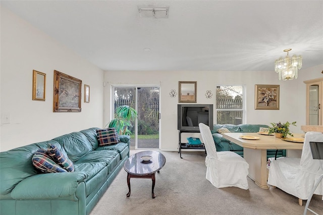 living room with carpet flooring and a chandelier