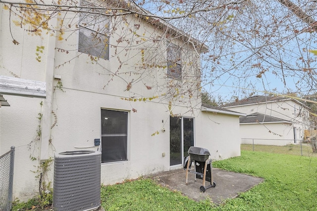 rear view of house featuring a yard, a patio, and central air condition unit