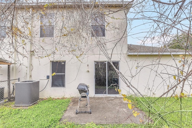 rear view of house with cooling unit and a patio