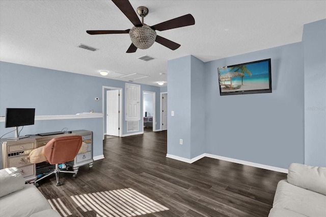 office space featuring ceiling fan, dark hardwood / wood-style floors, and a textured ceiling