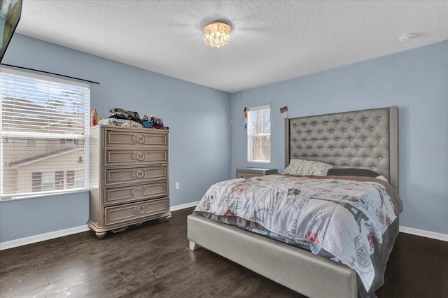 bedroom featuring dark hardwood / wood-style floors and a textured ceiling