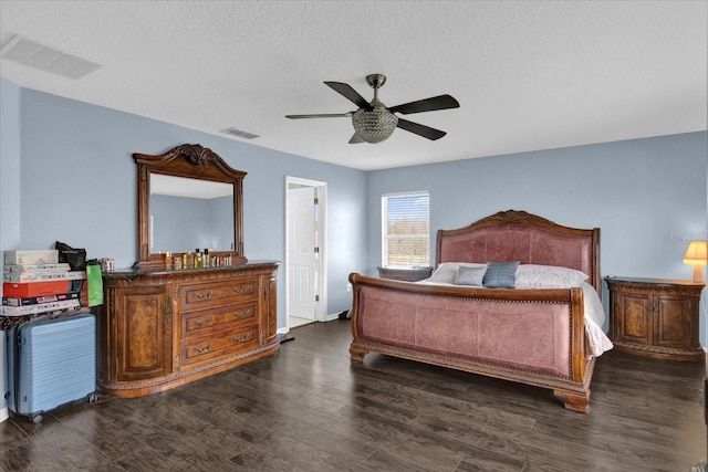 bedroom featuring ceiling fan, dark wood-type flooring, and a textured ceiling