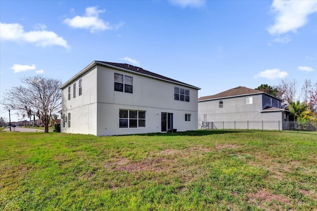 back of house featuring a yard