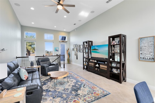 tiled living room with a towering ceiling and ceiling fan