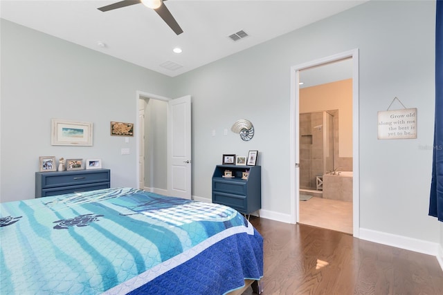 bedroom featuring ensuite bath, dark wood-type flooring, and ceiling fan