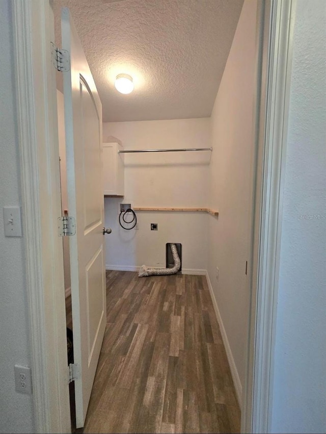 laundry room with gas dryer hookup, a textured ceiling, dark hardwood / wood-style flooring, washer hookup, and hookup for an electric dryer