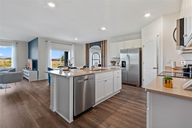 kitchen featuring appliances with stainless steel finishes, sink, a kitchen island with sink, and white cabinets