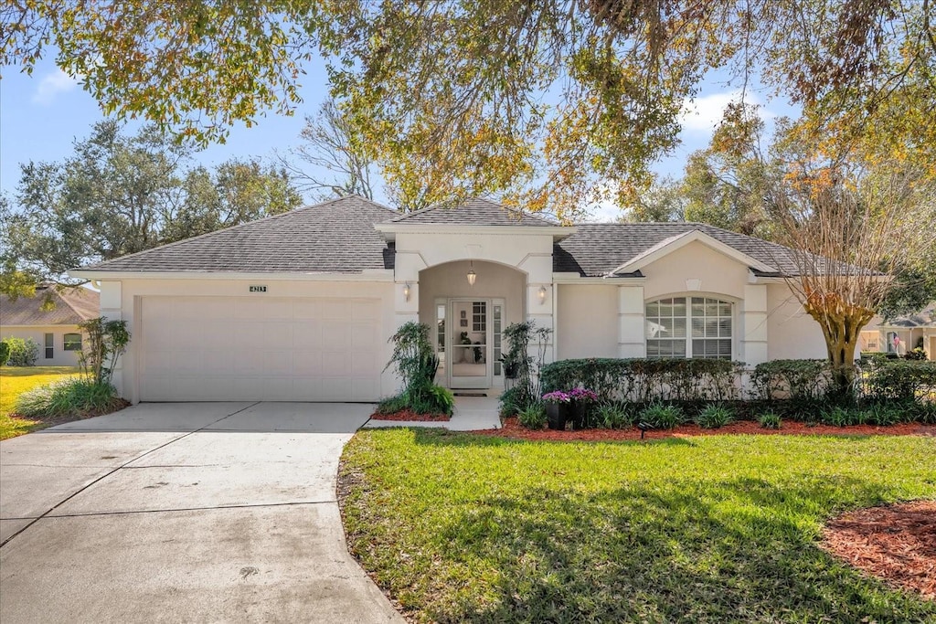 view of front of property with a garage and a front yard