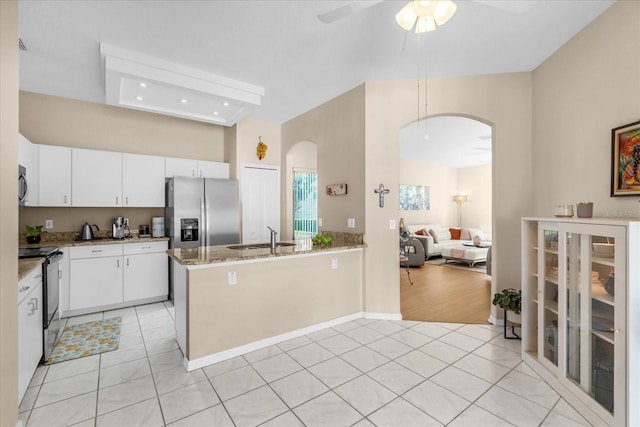 kitchen with white cabinetry, appliances with stainless steel finishes, sink, and light tile patterned floors