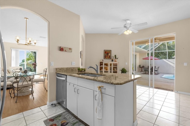 kitchen featuring light tile patterned flooring, sink, stainless steel dishwasher, pendant lighting, and white cabinets