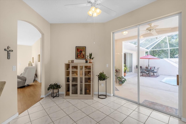 entryway featuring light tile patterned flooring and ceiling fan