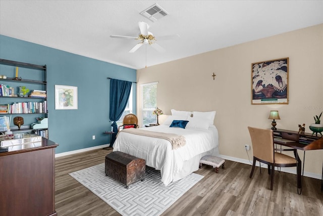 bedroom with dark hardwood / wood-style floors and ceiling fan