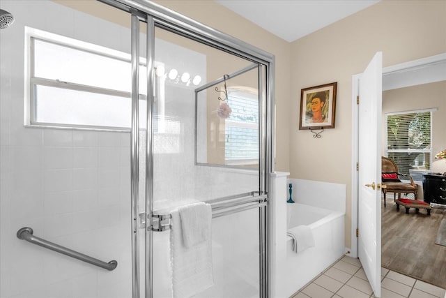 bathroom with a healthy amount of sunlight, tile patterned floors, and shower with separate bathtub