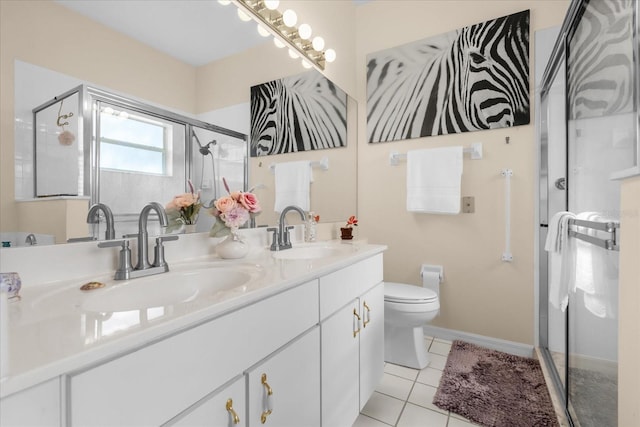 bathroom featuring tile patterned flooring, vanity, toilet, and a shower with shower door