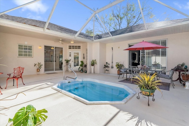 view of swimming pool featuring a patio area, ceiling fan, and glass enclosure