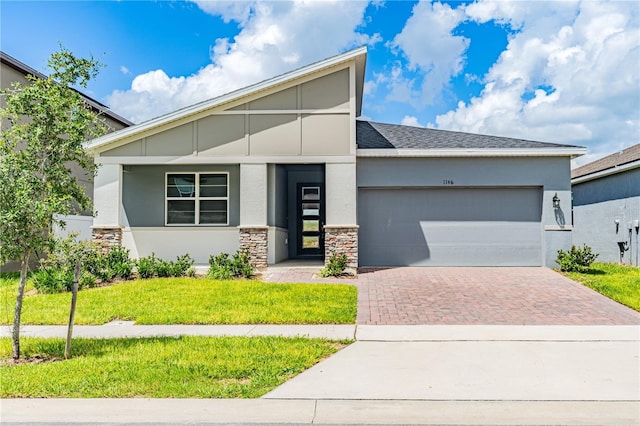 view of front of house with a garage and a front lawn