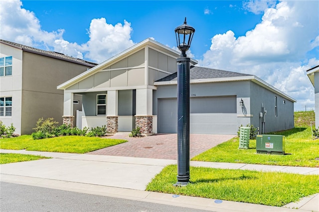 view of front of property with a garage and a front yard