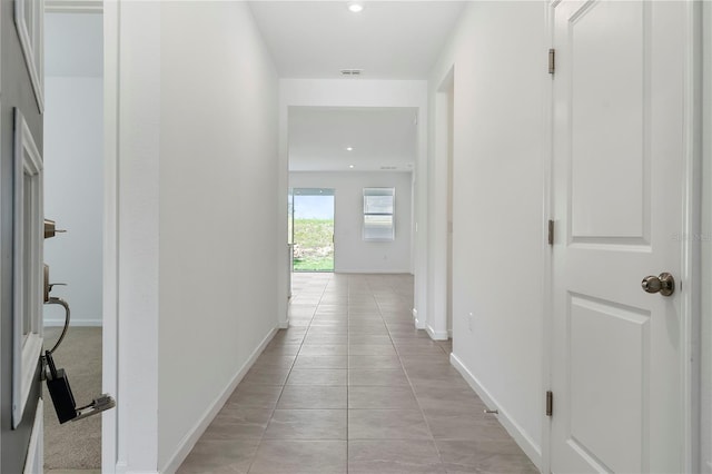 corridor with light tile patterned flooring