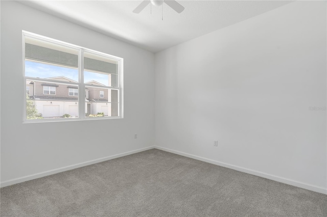 unfurnished room featuring ceiling fan and carpet flooring