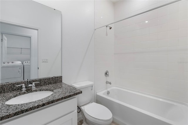 full bathroom featuring vanity, bathtub / shower combination, independent washer and dryer, and toilet