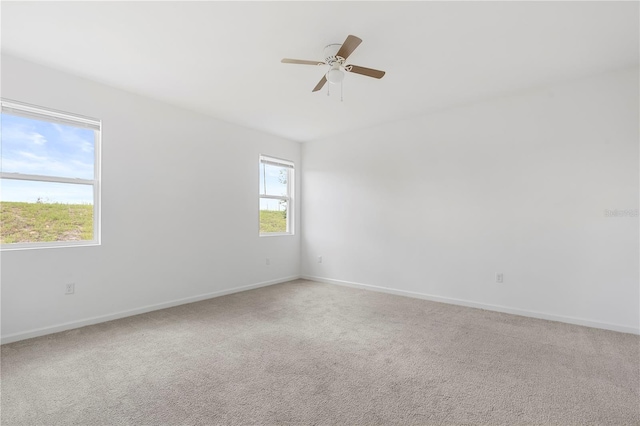 unfurnished room featuring ceiling fan and carpet