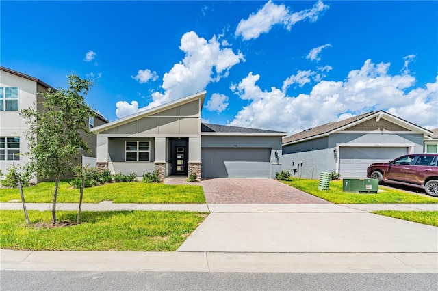 view of front of property featuring a garage and a front yard