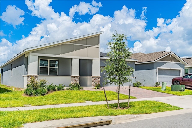 view of front of home with a garage and a front lawn