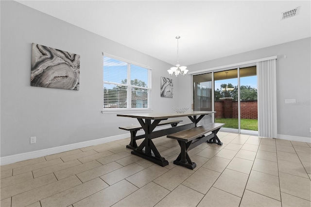 dining room featuring light tile patterned floors and a chandelier