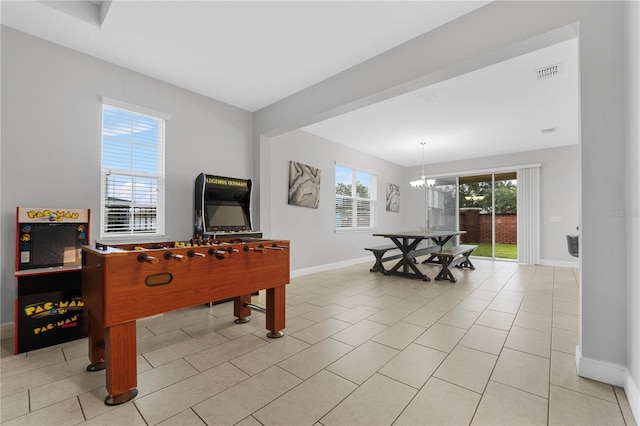 game room featuring a chandelier and light tile patterned floors