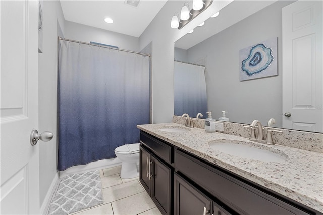 bathroom featuring vanity, toilet, and tile patterned flooring