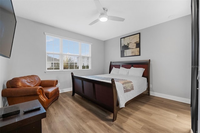 bedroom with ceiling fan and hardwood / wood-style floors