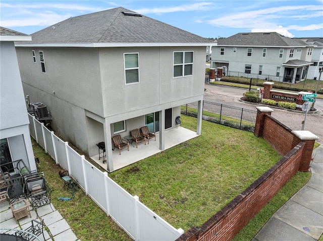 back of property featuring a yard and a patio area