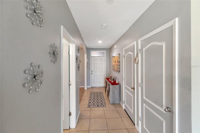 corridor featuring light tile patterned floors