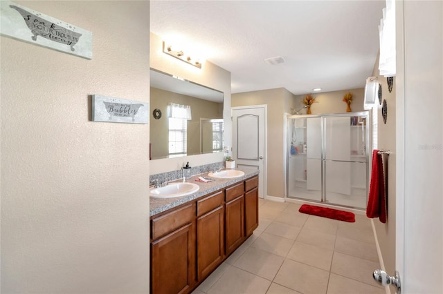 bathroom featuring walk in shower, tile patterned floors, and vanity