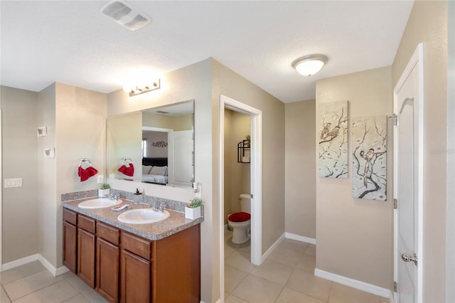 bathroom with vanity, tile patterned floors, and toilet