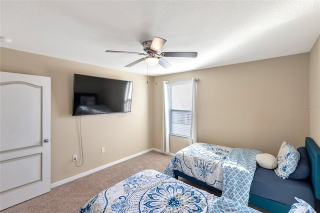 bedroom with light colored carpet, a textured ceiling, and ceiling fan