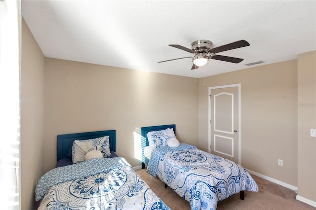 carpeted bedroom with ceiling fan